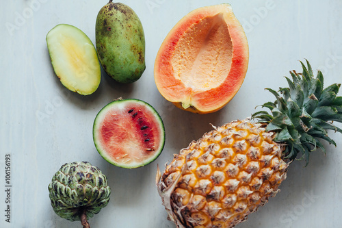 Exotic fruits variety on white table. Sliced fresh fruits on tab