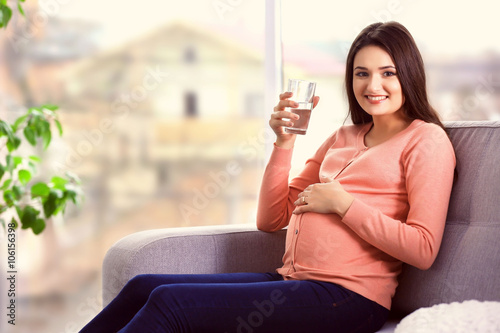Pregnant woman with a glass...