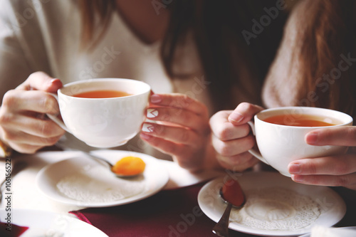 Womans with cup of tea on table in cafe or restaurant