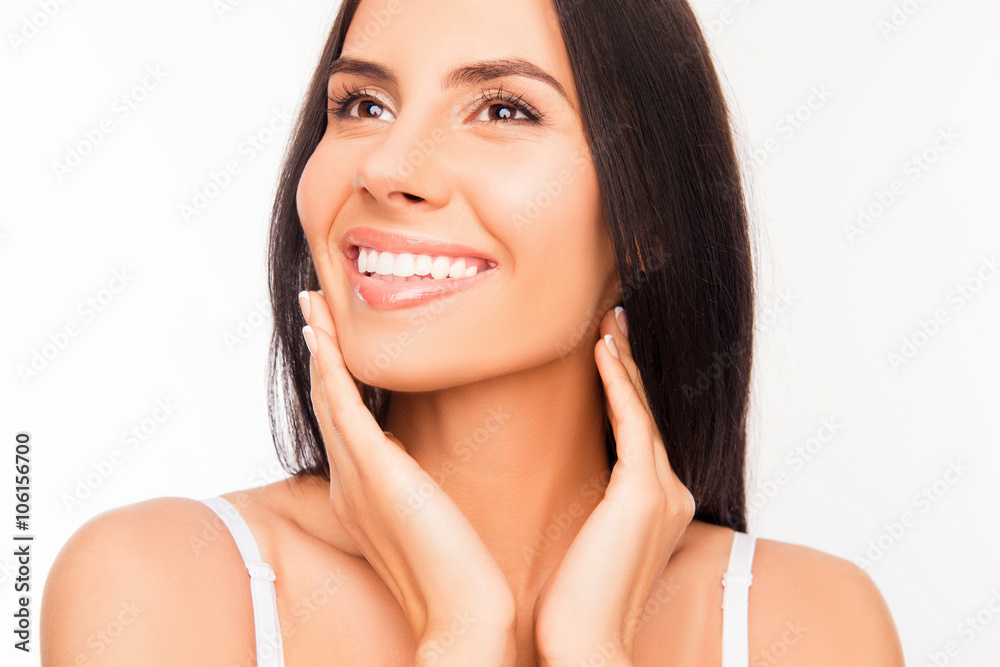 Young attractive young woman touching her face and smiling Young attractive young woman touching her face and smiling