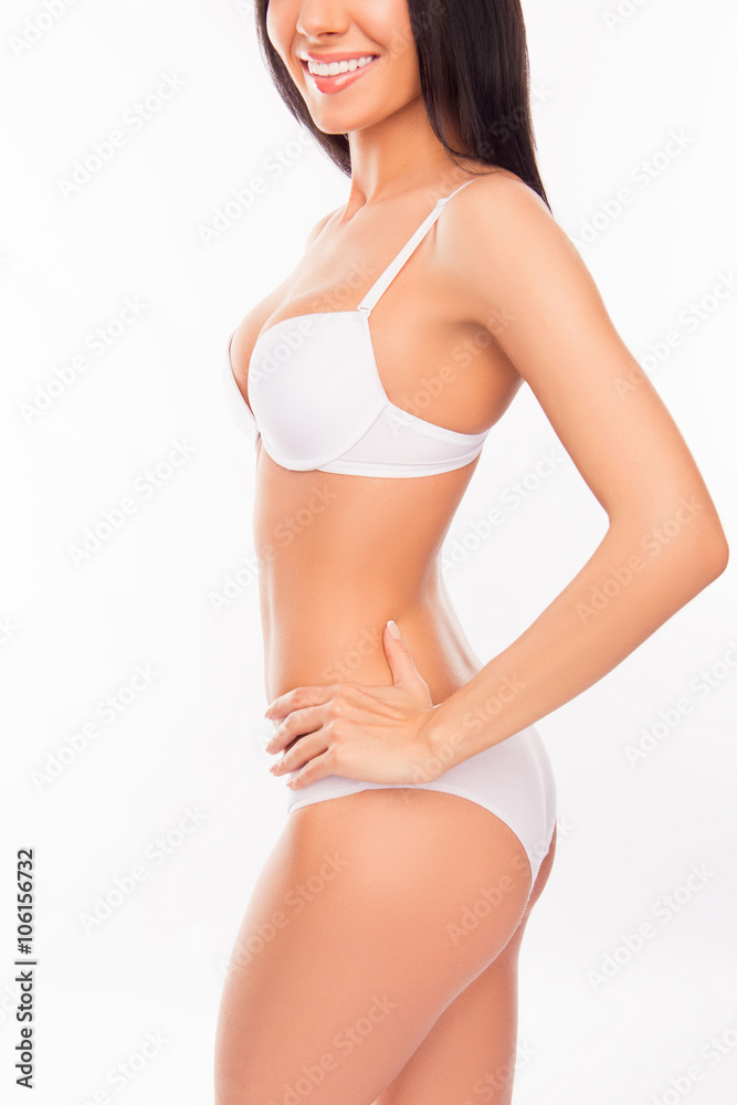 Side view photo of cheerful smiling young woman in white lingeri Side view photo of cheerful smiling young woman in white lingeri