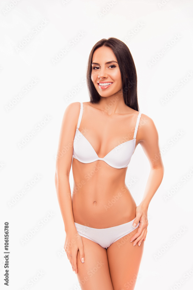 Cheerful healthy slim brunette posing in white lingerie Cheerful healthy slim brunette posing in white lingerie