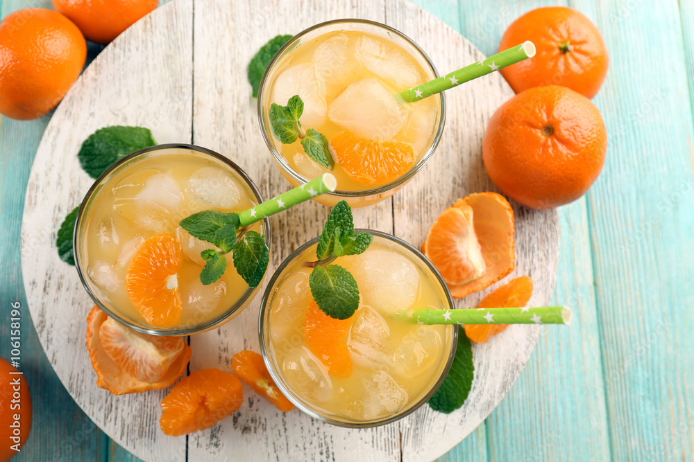 Fresh cocktails with ice, mint and tangerines on a white wooden board, top view Fresh cocktails with ice, mint and tangerines on a white wooden board, top view