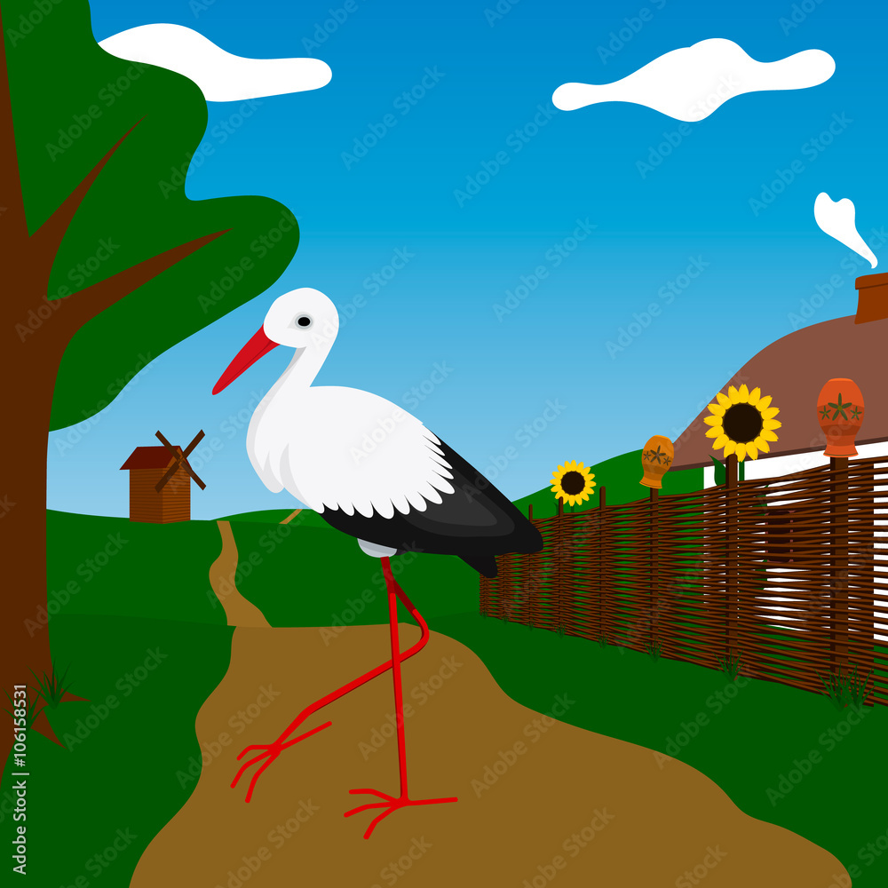 Fototapeta premium Stork near white house with fence