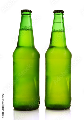 Two green glass bottles with beer, isolated on white