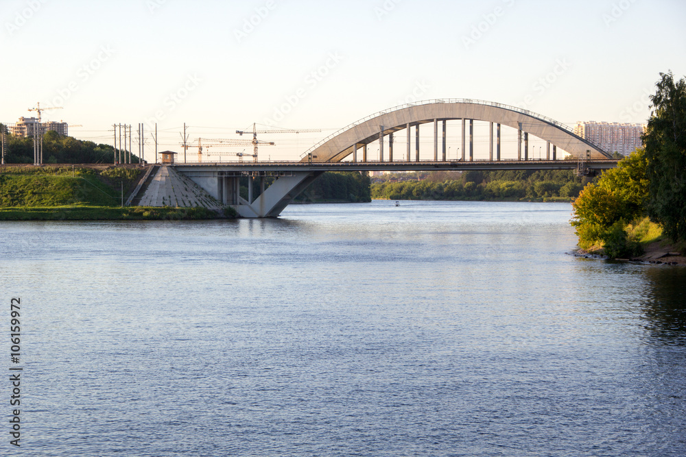 railway bridge over river in evening