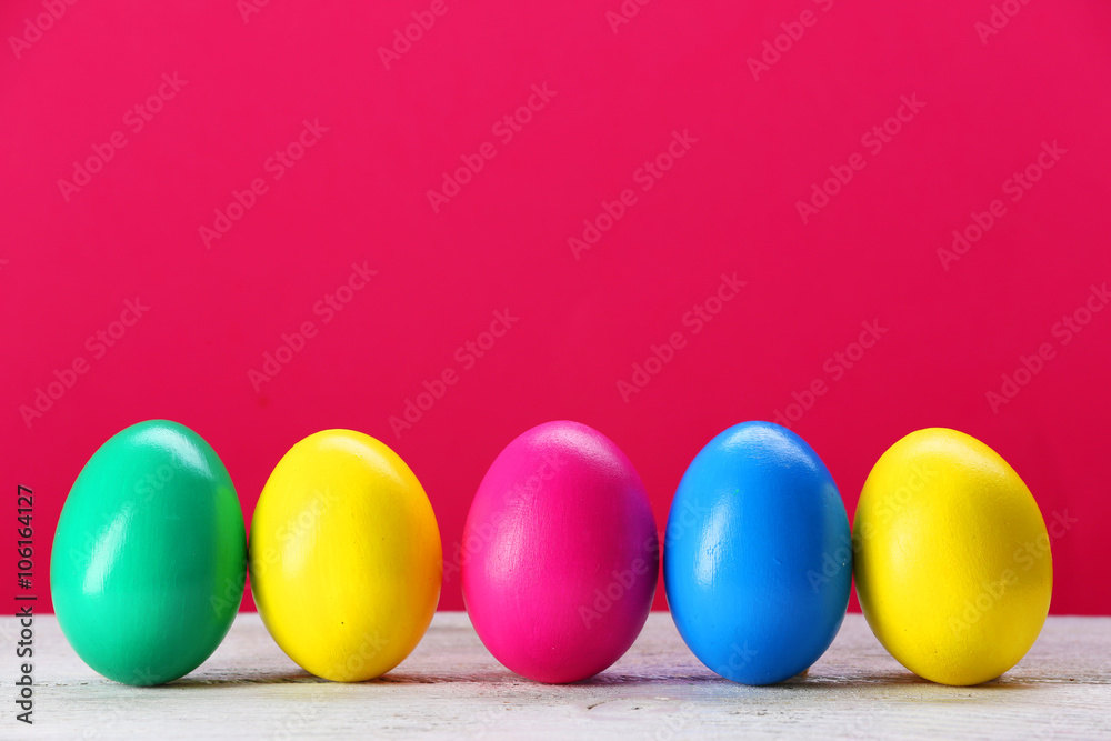 Colorful Easter eggs on pink background