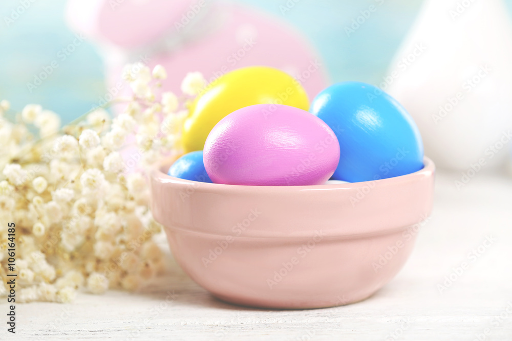 Colorful Easter eggs in bowl on wooden table, closeup Colorful Easter eggs in bowl on wooden table, closeup