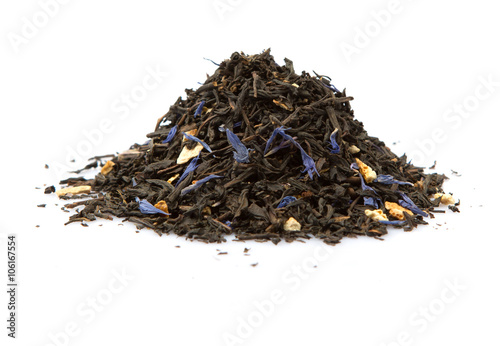 Dried black Earl Grey tea leaves over white background