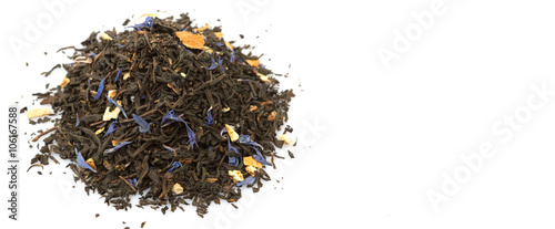 Dried black Earl Grey tea leaves over white background photo