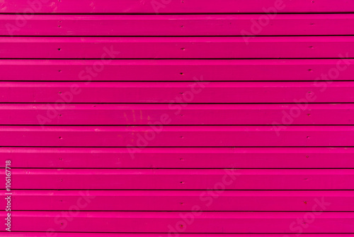 Section of pink wood panelling from a beach hut, suitable for backgrounds of beach, seaside and summer holiday themes.