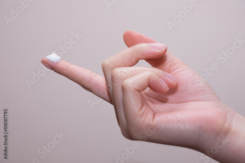 Beautiful young woman hands with cream