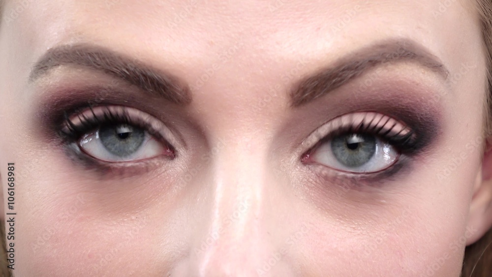 Girls blue eyes in wonder. Close up
