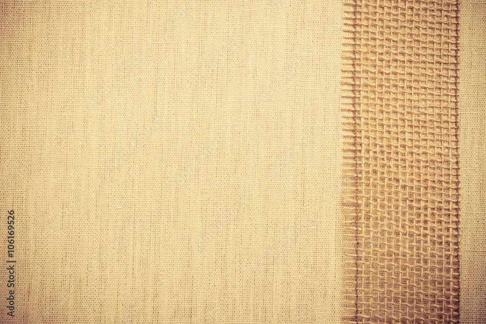 Fototapeta premium Jute ribbon on linen cloth background