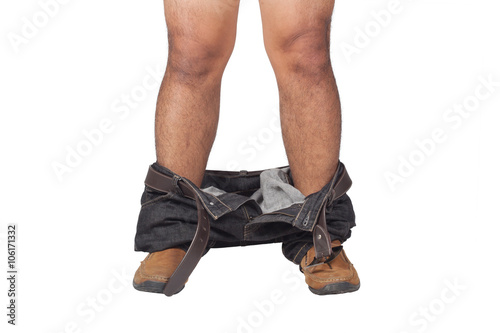 closeup of a young Asian man with his denim pants down, seen from front view on white background