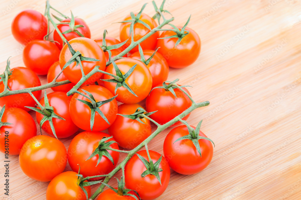A lot of cherry tomatoes on cutting board A lot of cherry tomatoes on cutting board