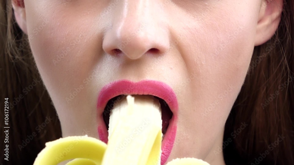 Female mouth eating peeled banana. Close up. Slow motion Female mouth eating peeled banana. Close up. Slow motion