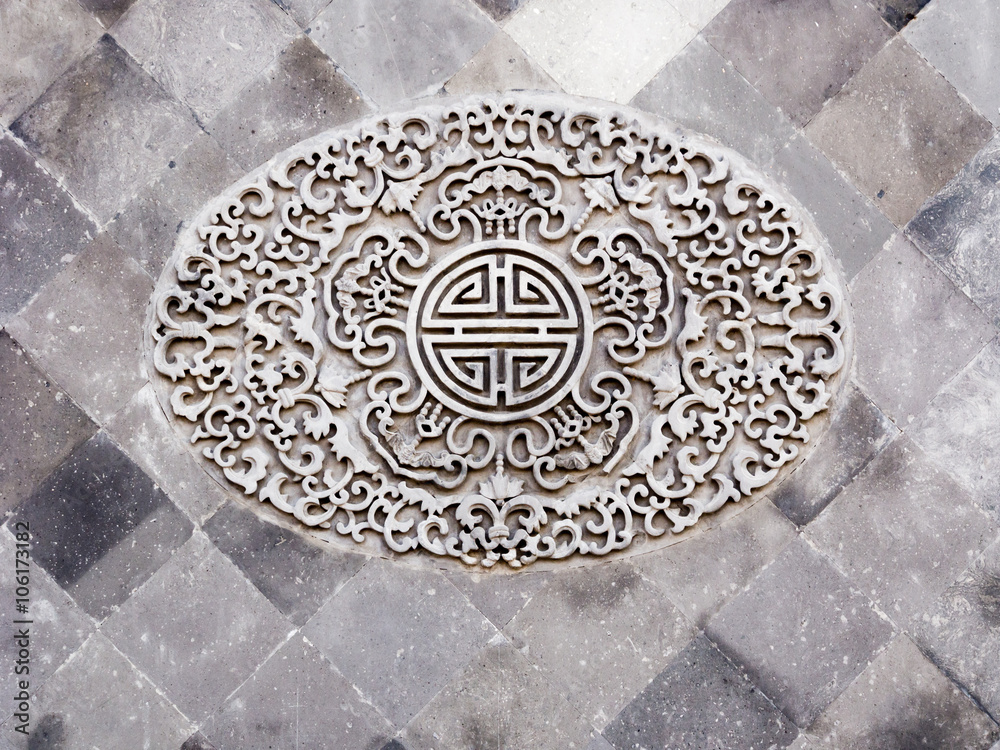 Classical Chinese ornamental design on grey brick wall