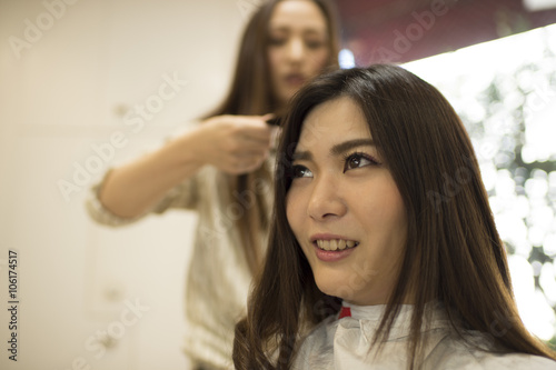 Hairdresser curled the hair of women