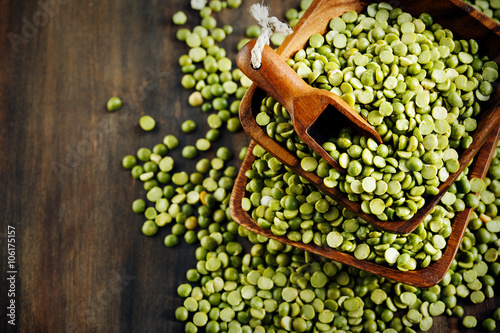 Dry green peas on wooden background