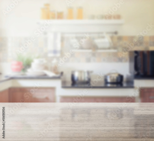 granite table top and blur of modern kitchen interior as background