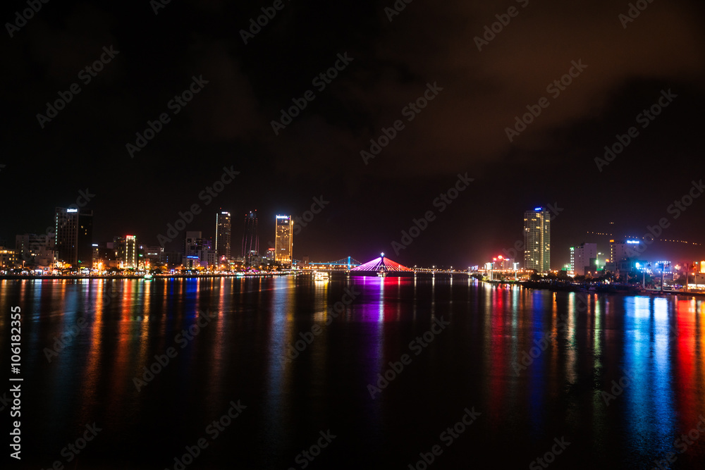 Cityscape of Da Nang city in Vietnam, with night illumination and modern buildings.