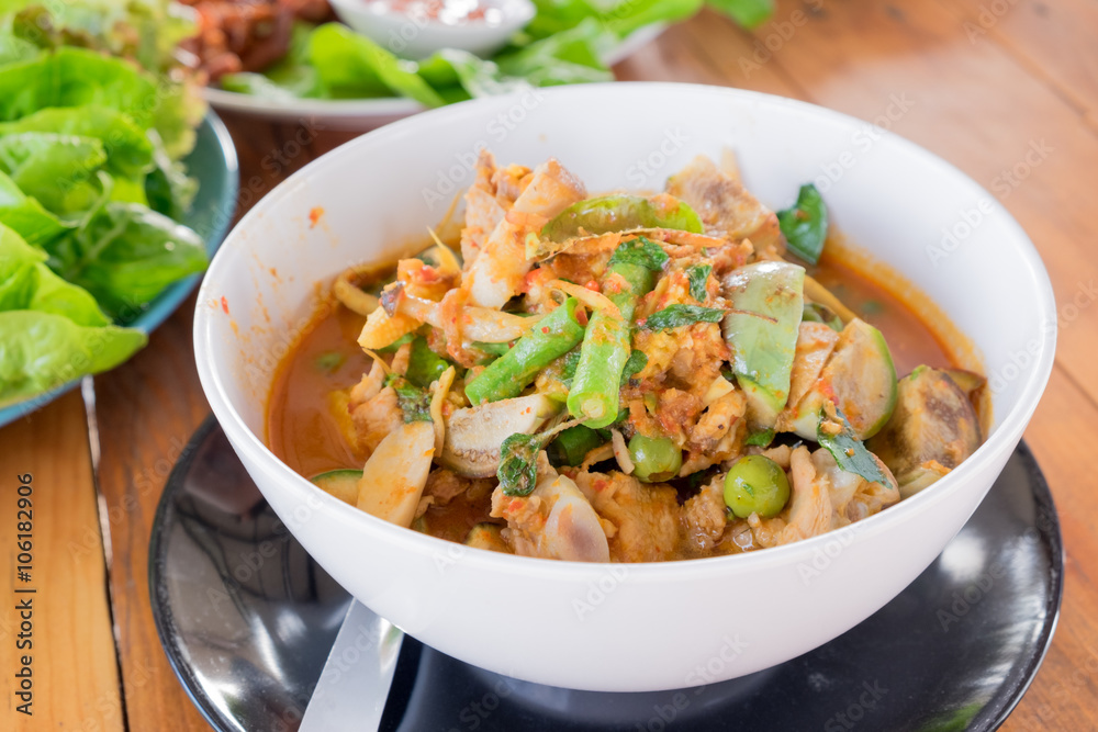 Close up spicy red curry with chicken and herbs Close up spicy red curry with chicken and herbs