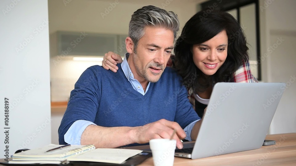 Couple at home using laptop computer