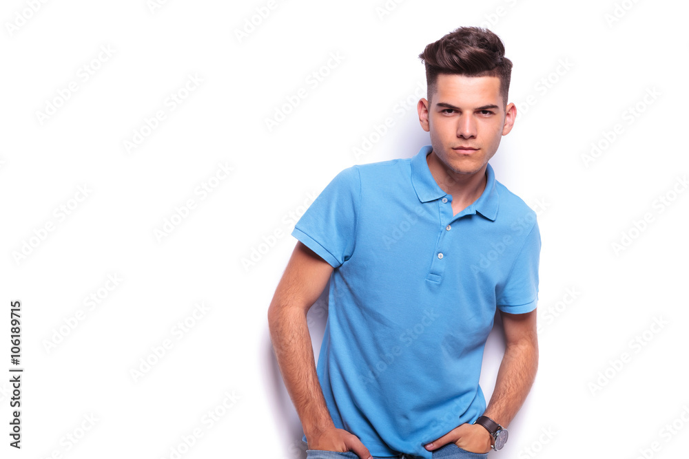 Fototapeta premium boy in polo shirt posing hands in pockets while leaning