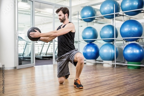 Man doing exercise with medicine ball