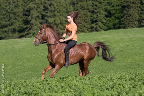 Young girl riding on horse © lenkadan