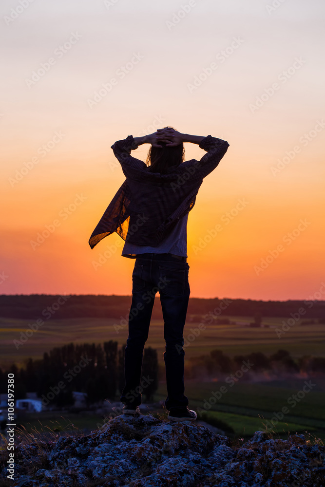 Silhouette of young longhair male model.