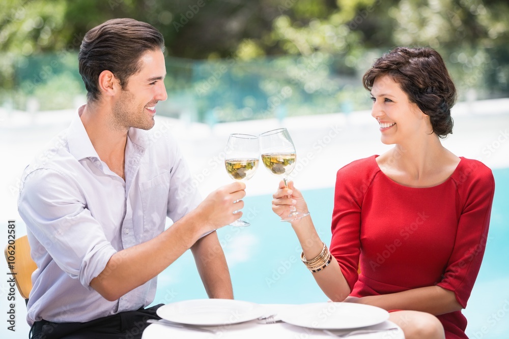 Smiling couple toasting white wine Smiling couple toasting white wine