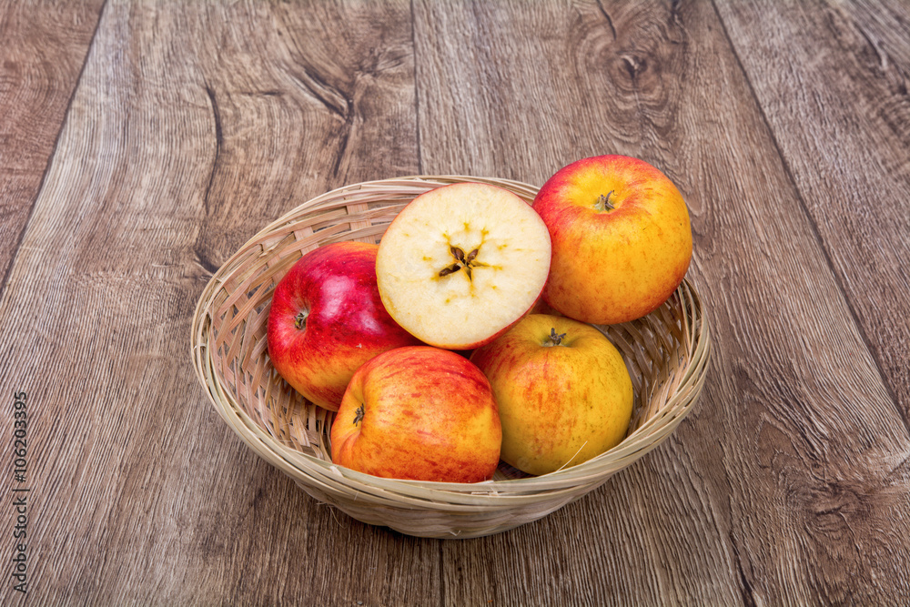 Apples in a knitted bowl on a wooden background Apples in a knitted bowl on a wooden background