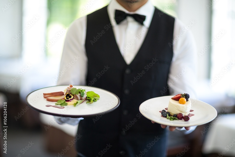 Waiter showing a dish