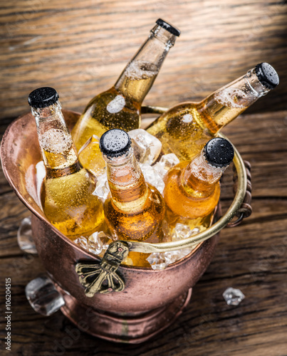 Cold bottles of beer in the brazen bucket.