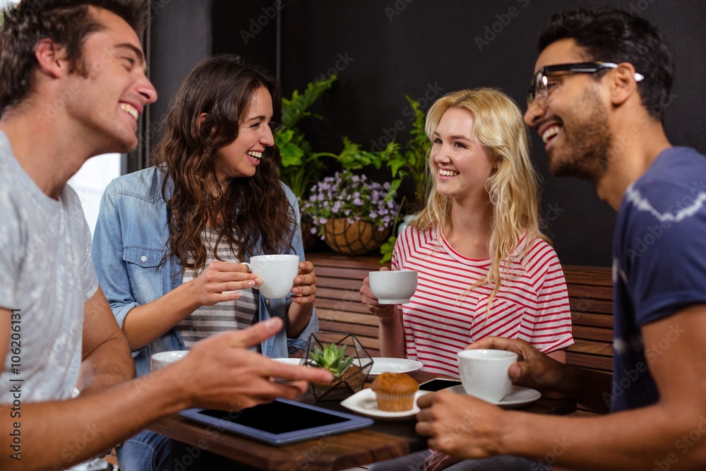 Smiling friends enjoying coffee together Smiling friends enjoying coffee together