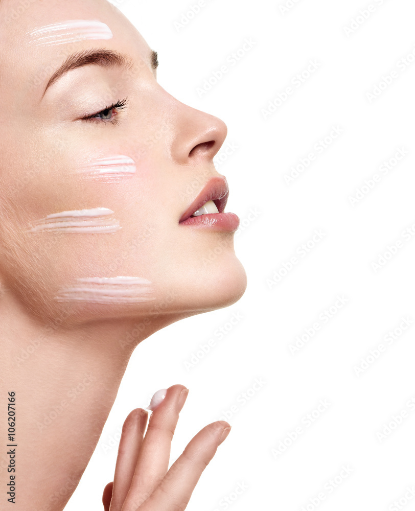 Beautiful Young Woman applying facial moisturizing cream.Skincar Beautiful Young Woman applying facial moisturizing cream.Skincar