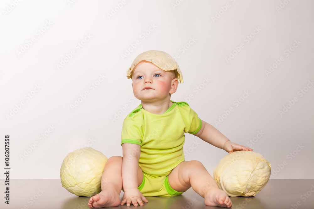 Fototapeta premium child with cabbage on a white background in studio