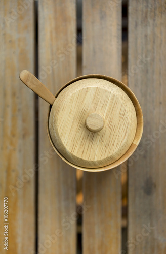 Wooden sugar bow on wood background vertical style