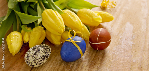 Colorful Easter eggs and tulips.