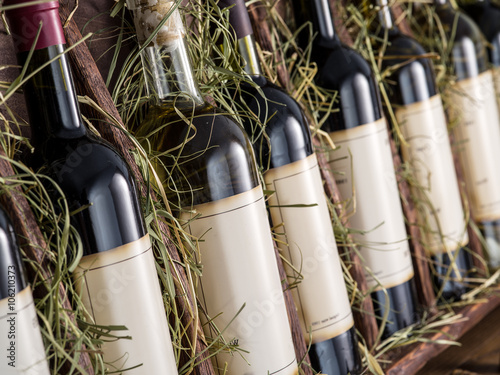 Wine bottles on the wooden shelf.