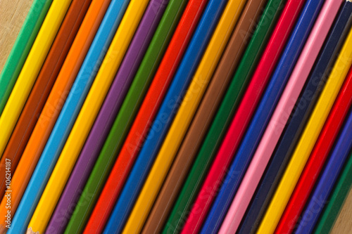 Several wooden colored pencils in a row for background