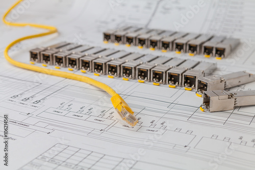 Electric gigabit sfp modules for network switch on the blueprint of  communication equipment and patch cord photo