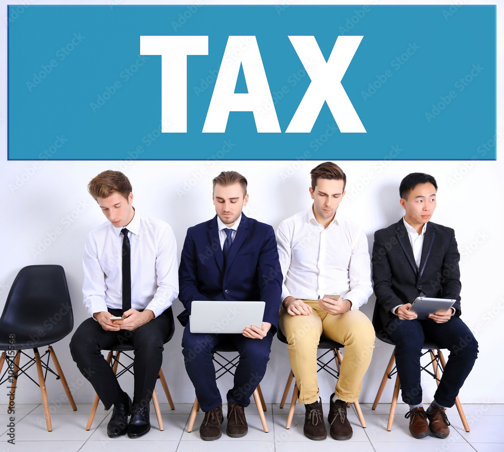 Tax concept. Young businessmen sitting on a chair and using devices in