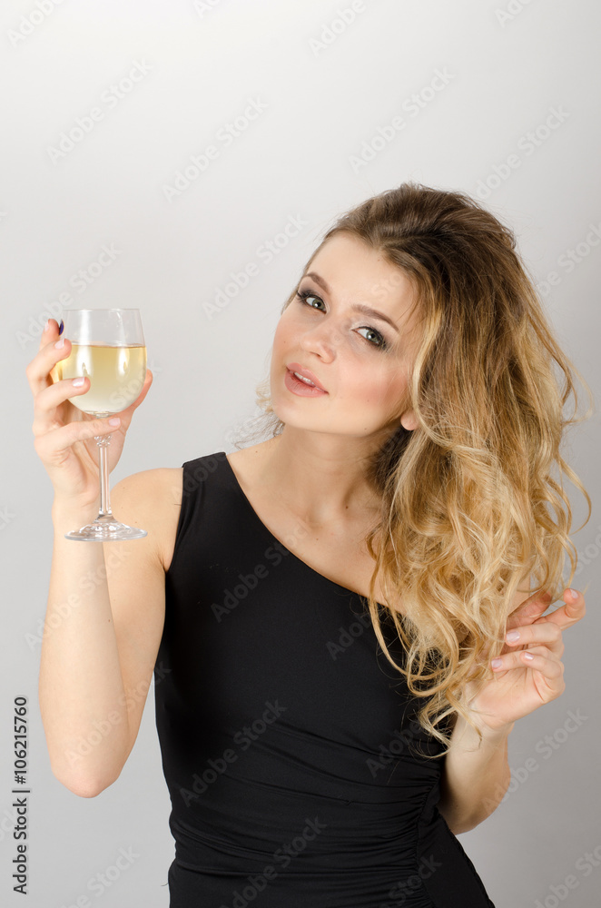 Beautiful blond woman drinking white wine