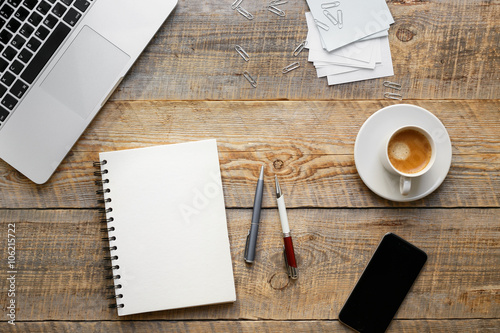 Working place with notebook on wooden table