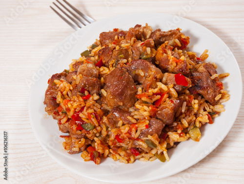 Rice with meat and vegetables on plate