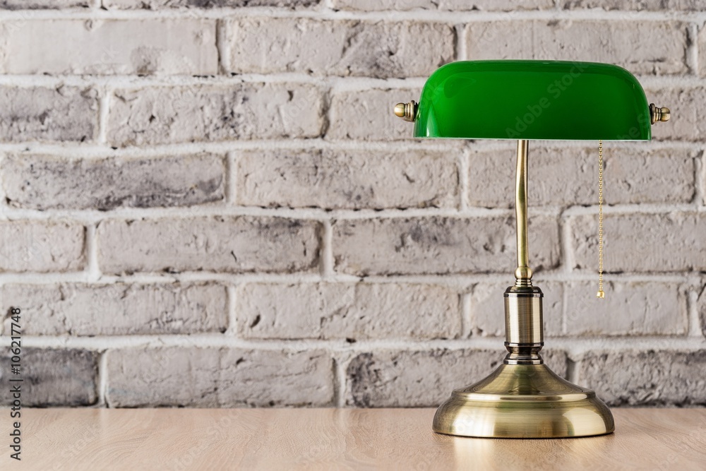 Green and gold banker lamp on the desk