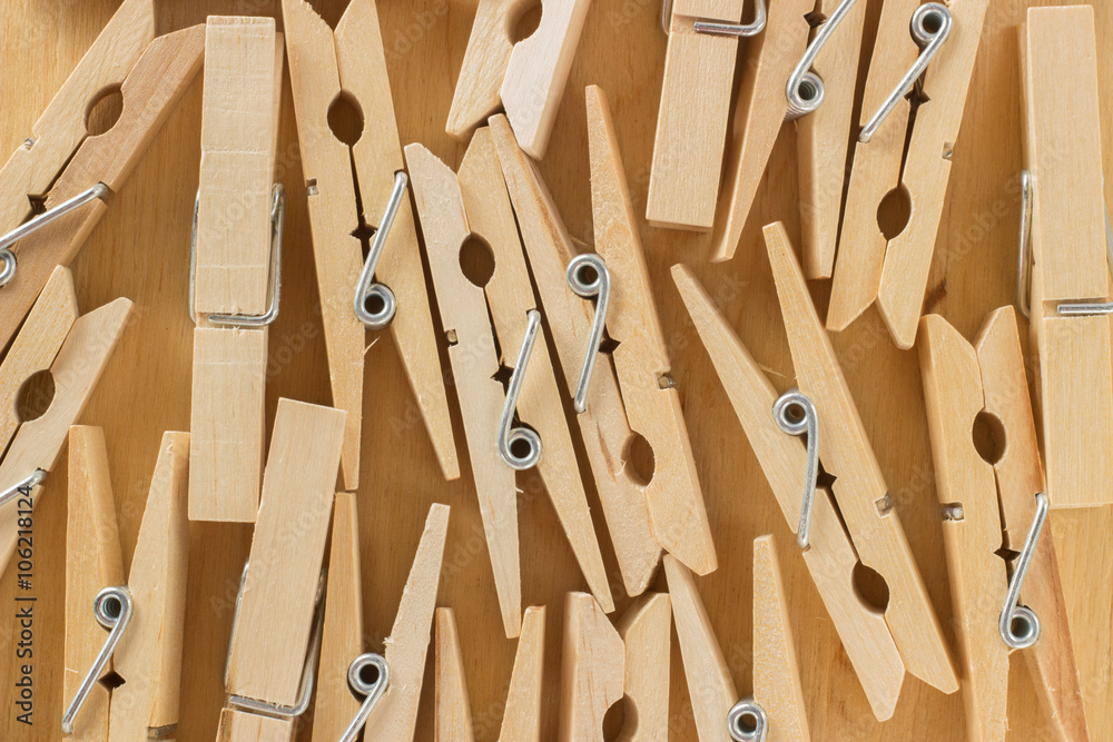 The background of a number of wooden clothespins on a table The background of a number of wooden clothespins on a table